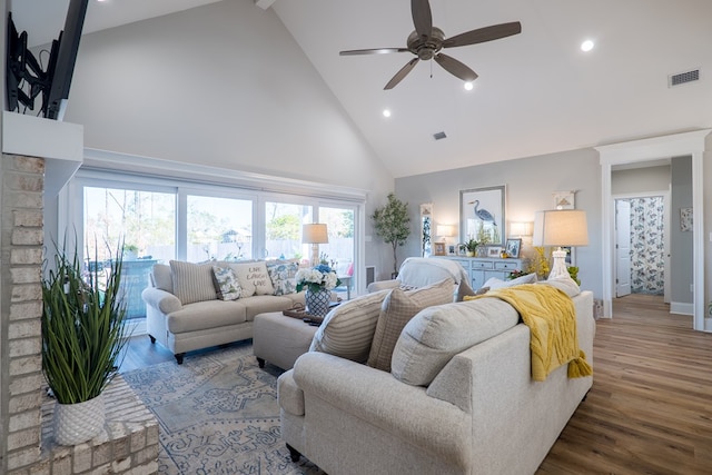 living room featuring ceiling fan, high vaulted ceiling, and hardwood / wood-style flooring