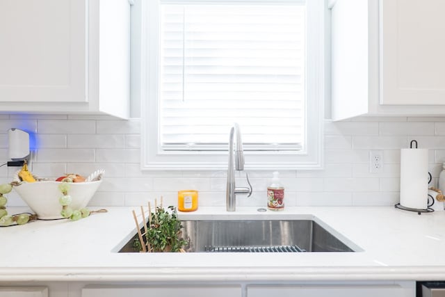 details with white cabinets and decorative backsplash