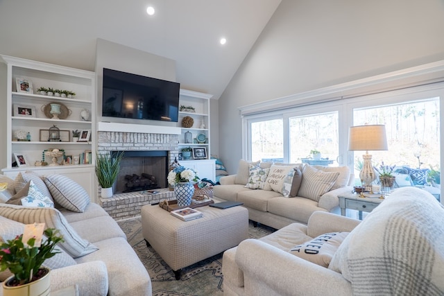 living room featuring built in features, high vaulted ceiling, and a brick fireplace