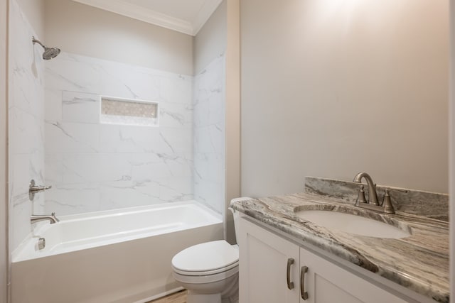 full bathroom with crown molding, toilet, vanity, and tiled shower / bath