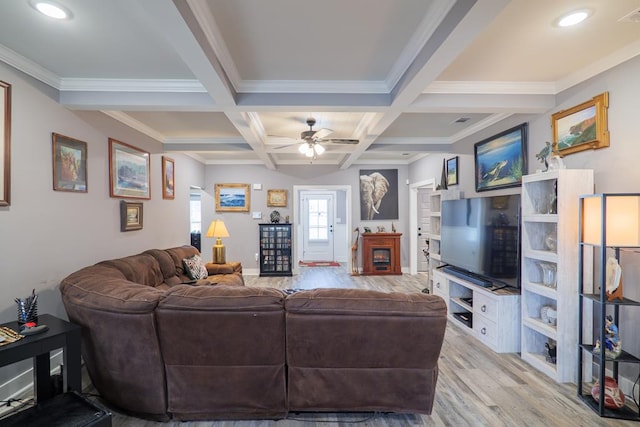 living room with beam ceiling, light wood-type flooring, ceiling fan, crown molding, and coffered ceiling