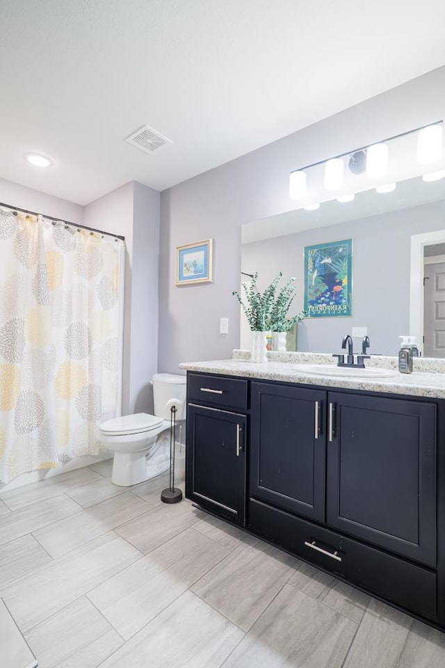 bathroom with toilet and vanity