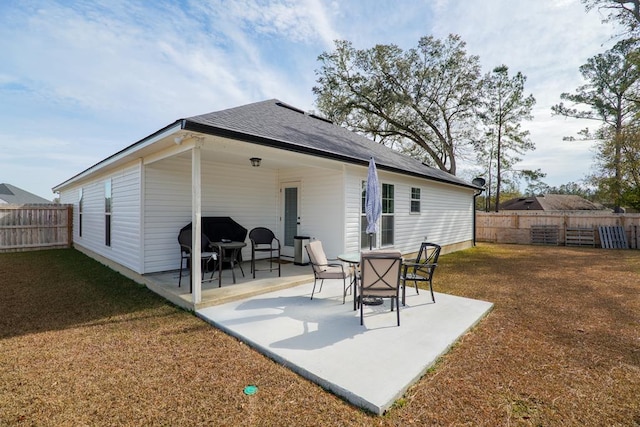 rear view of property with a patio area and a yard