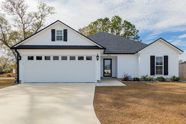 view of front of home featuring a garage and a front yard