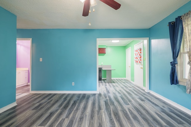 5209 Sequani Cir, Lake Park, GA 31636 - unfurnished living room with wood finished floors, a ceiling fan, and a textured ceiling