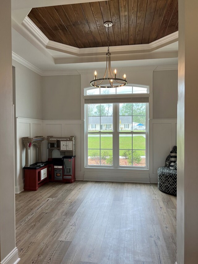 doorway featuring hardwood / wood-style flooring, a notable chandelier, wooden ceiling, and a tray ceiling