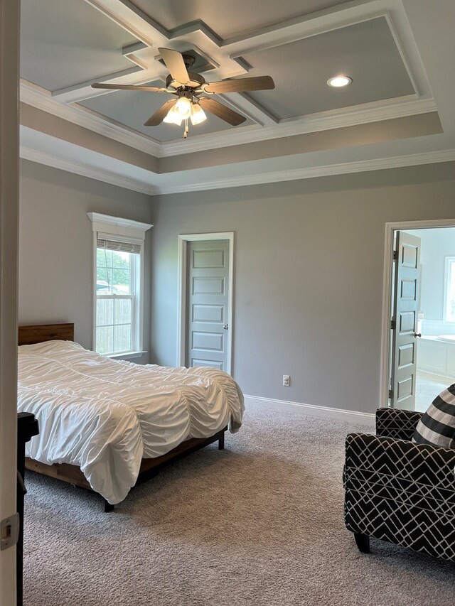 carpeted bedroom with a raised ceiling, ensuite bath, ceiling fan, and crown molding