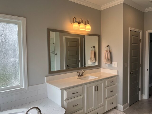 bathroom featuring a tub, plenty of natural light, vanity, and ornamental molding