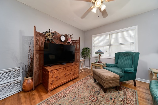 sitting room featuring light hardwood / wood-style flooring, ceiling fan, and vaulted ceiling