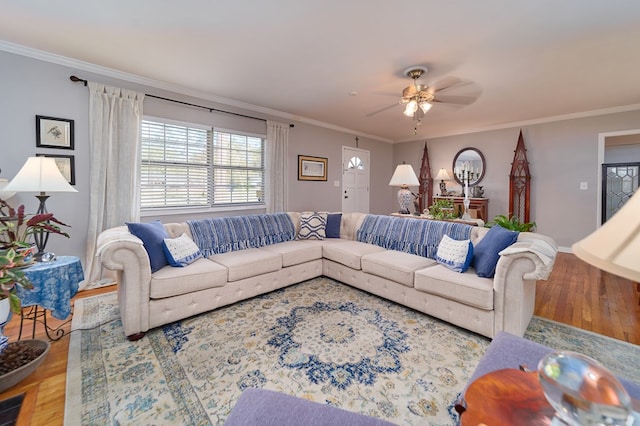 living room with crown molding, ceiling fan, and hardwood / wood-style flooring