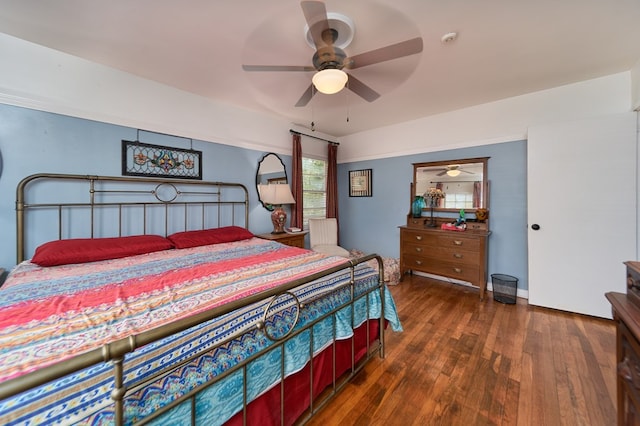 bedroom with dark wood-type flooring and ceiling fan