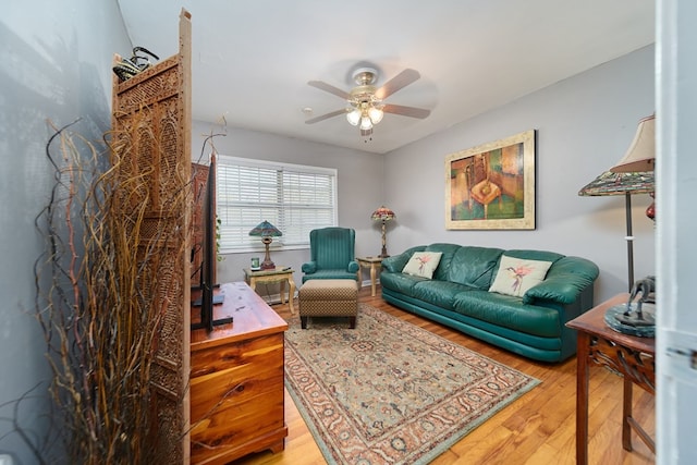 living room featuring hardwood / wood-style floors and ceiling fan