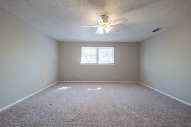 carpeted empty room featuring ceiling fan and a textured ceiling