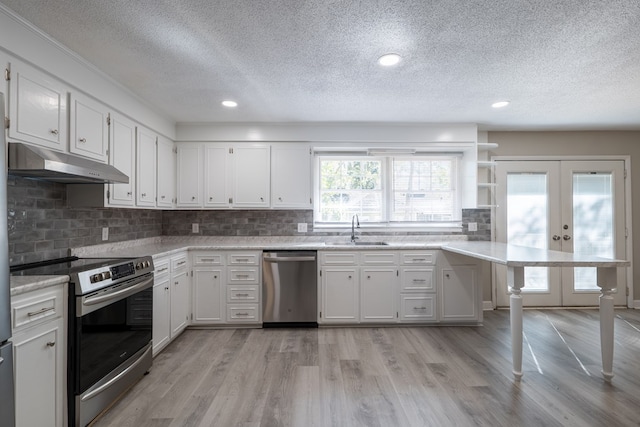 kitchen with white cabinetry, french doors, stainless steel appliances, and sink