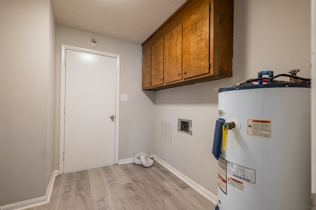 laundry area with cabinets, hookup for a washing machine, a textured ceiling, water heater, and light hardwood / wood-style flooring