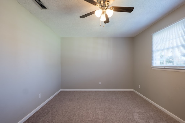 spare room with carpet, a textured ceiling, and ceiling fan