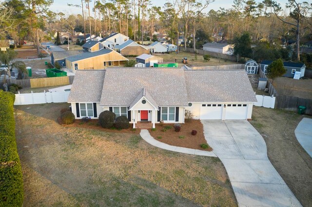 view of front of property with a garage and a front lawn