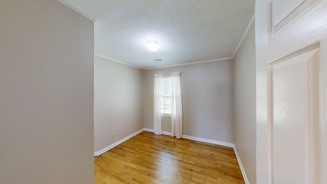 5408 S Camellia Dr, Valdosta, GA 31601 - unfurnished room featuring crown molding, light wood finished floors, baseboards, and a textured ceiling