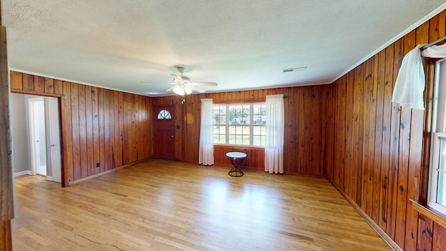 5408 S Camellia Dr, Valdosta, GA 31601 - empty room with a ceiling fan, wood finished floors, a textured ceiling, wood walls, and baseboards