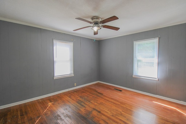 1115 Albert Rd, Valdosta, GA 31601 - empty room featuring hardwood / wood-style floors, healthy amount of natural light, a ceiling fan, and crown molding