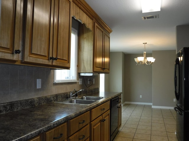 3575 Beulah Cir, Valdosta, GA 31605 - kitchen featuring black appliances, dark countertops, tasteful backsplash, a chandelier, and brown cabinets