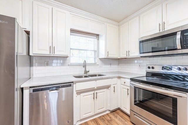 kitchen with white cabinetry, sink, a textured ceiling, and appliances with stainless steel finishes