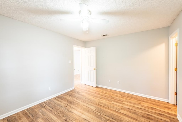 unfurnished room with ceiling fan, light hardwood / wood-style floors, and a textured ceiling