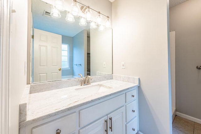 bathroom with tile patterned flooring and vanity