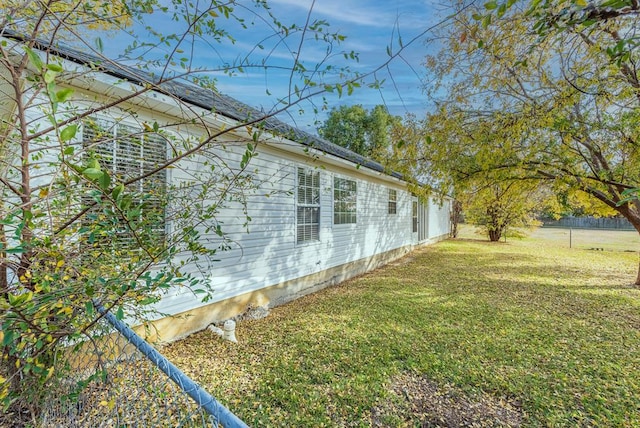 view of side of home featuring a yard