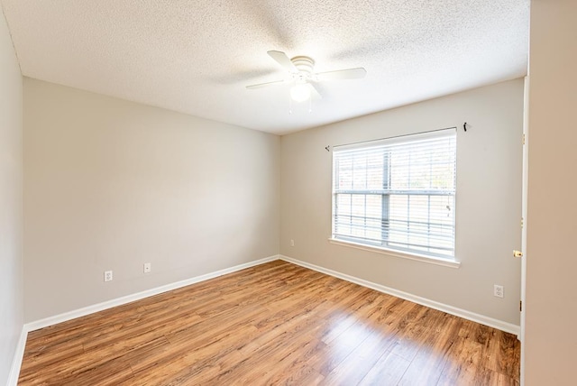 spare room featuring a textured ceiling, light hardwood / wood-style floors, and ceiling fan