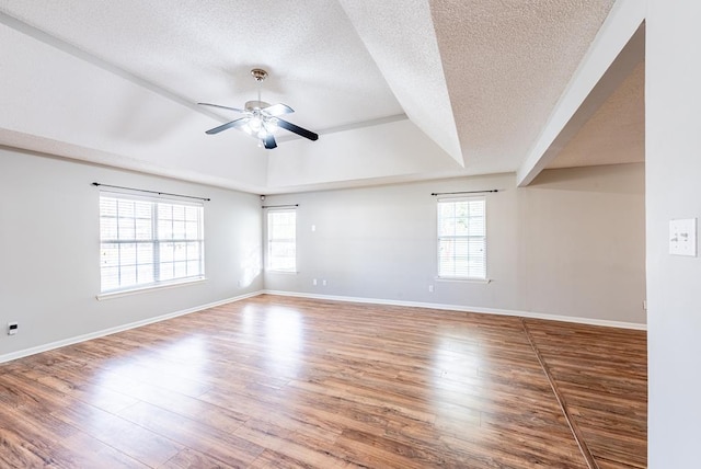 spare room with ceiling fan, wood-type flooring, and a textured ceiling