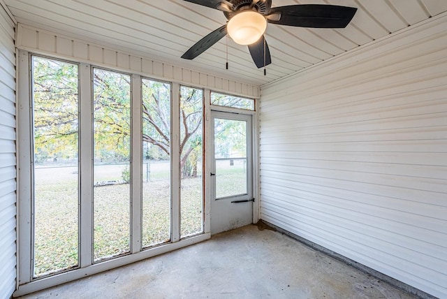 unfurnished sunroom featuring ceiling fan