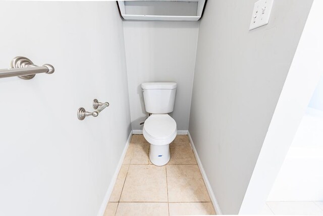 bathroom featuring tile patterned flooring and toilet