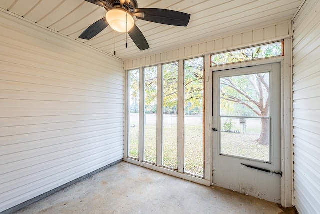 unfurnished sunroom featuring ceiling fan