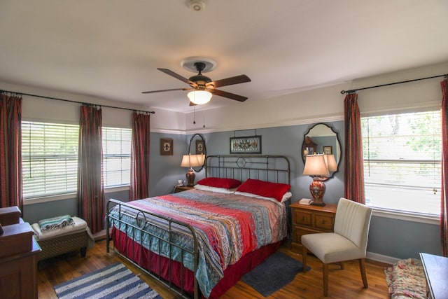 bedroom with a ceiling fan, baseboards, and wood finished floors