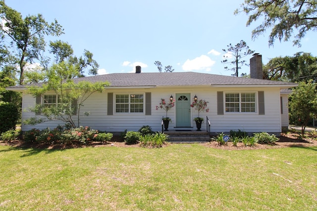 ranch-style house with a chimney and a front yard
