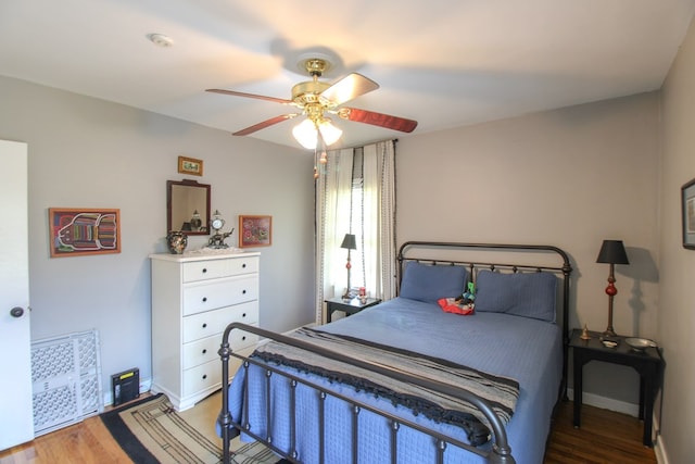 bedroom with baseboards, ceiling fan, and light wood-style flooring