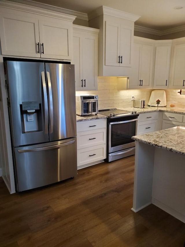 kitchen with white cabinetry, appliances with stainless steel finishes, and crown molding