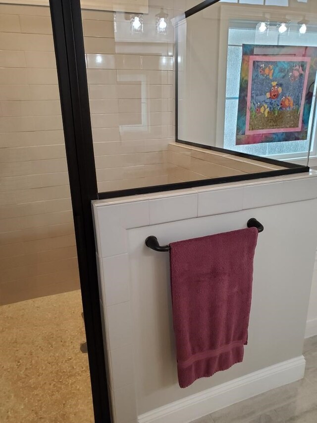 bathroom featuring walk in shower, a healthy amount of sunlight, and wood-type flooring