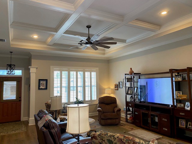 living room with hardwood / wood-style flooring, ceiling fan, coffered ceiling, and beamed ceiling