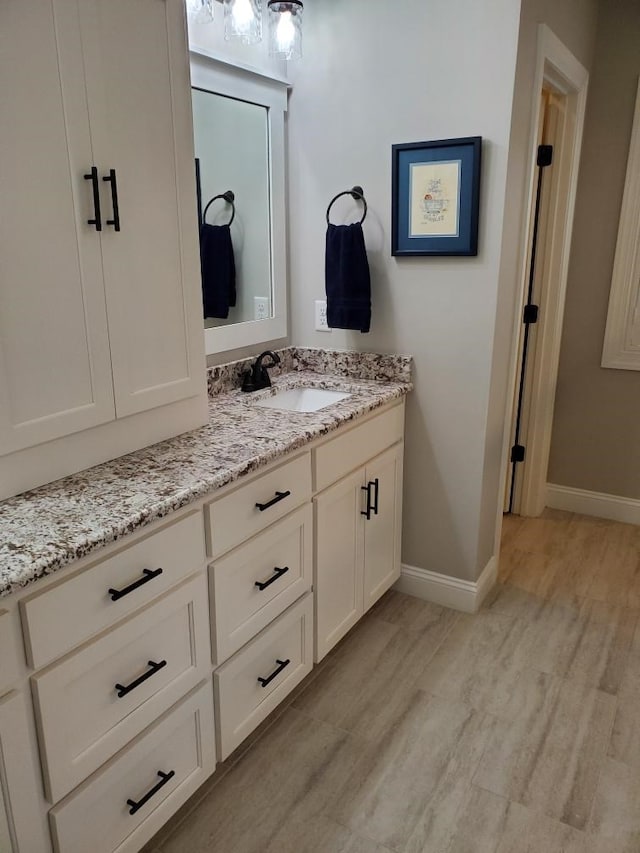 bathroom featuring wood-type flooring and vanity