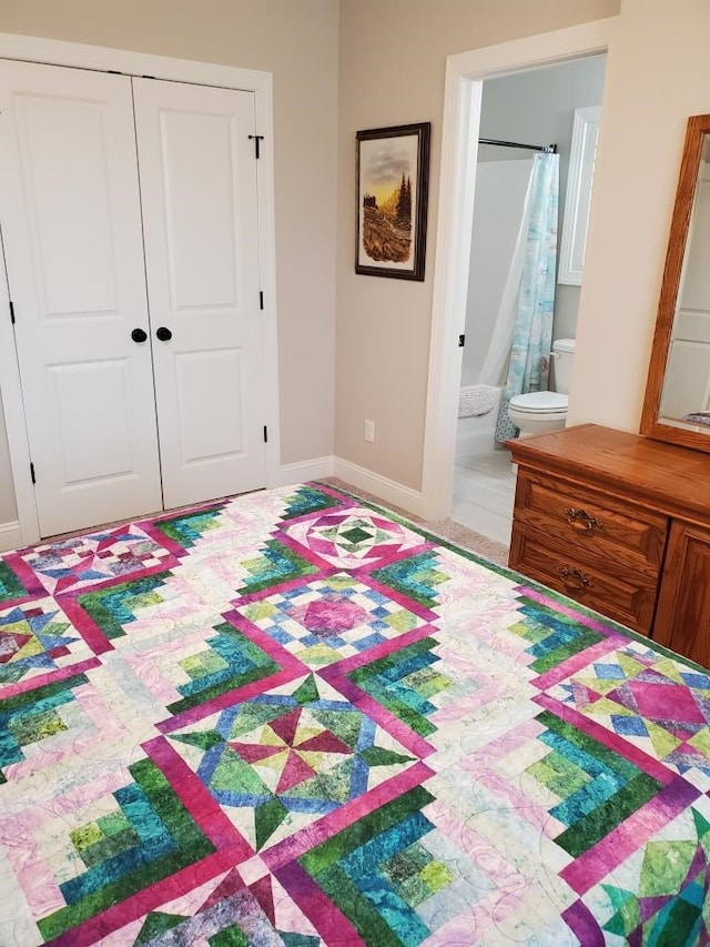 bedroom featuring connected bathroom and a closet