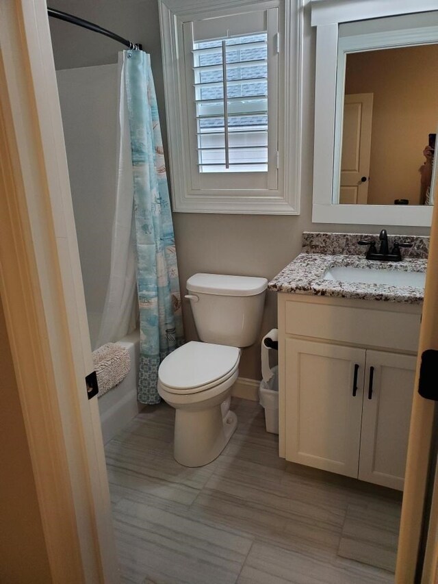 washroom with hardwood / wood-style floors and washer and dryer