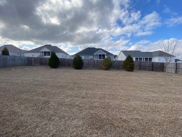 view of front of house featuring a garage and a front lawn