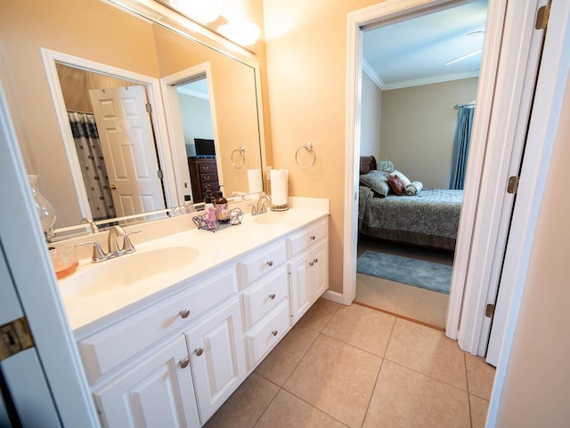 bathroom with tile patterned floors, crown molding, and vanity