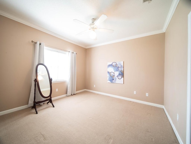 spare room with crown molding, ceiling fan, and light colored carpet