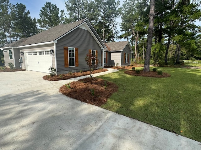 view of front of property featuring a garage and a front yard