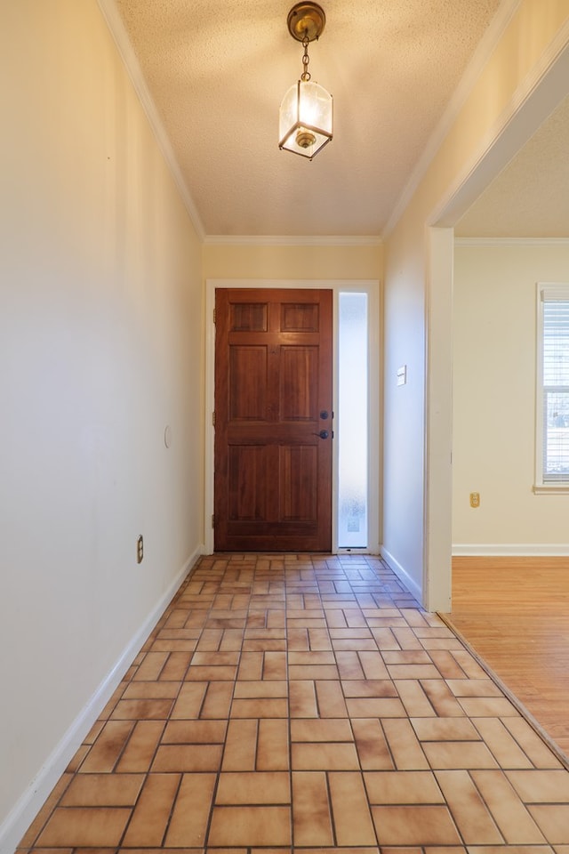 entrance foyer featuring a textured ceiling and ornamental molding