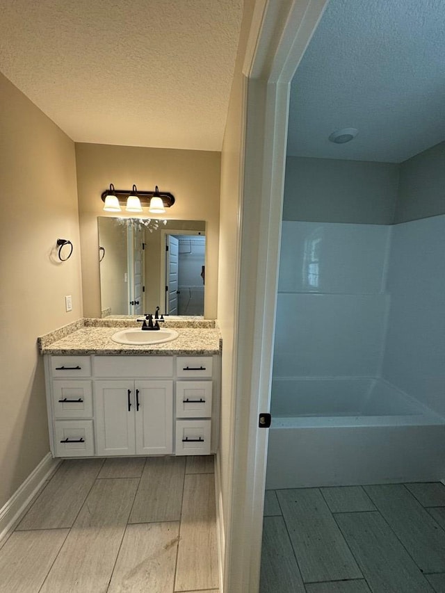 bathroom featuring vanity and a textured ceiling