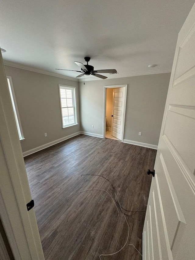 spare room with ceiling fan, dark hardwood / wood-style floors, and ornamental molding